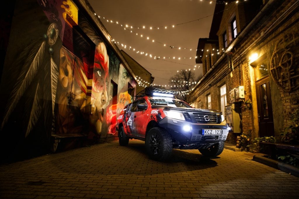 Igo2Dakar Nissan Navara under the Christmas lights next to Shnioka street art piece Giedrius Matulaitis matulaitis.lt